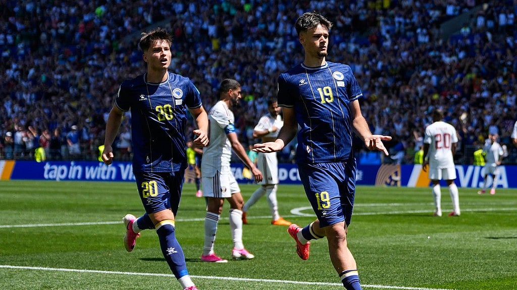 Bosnia's Kerim Alajbegovic, right, celebrates after scoring his side's opening goal during the World Cup Group B soccer match against Qatar in Seattle. - AP Photo/Lindsey Wasson