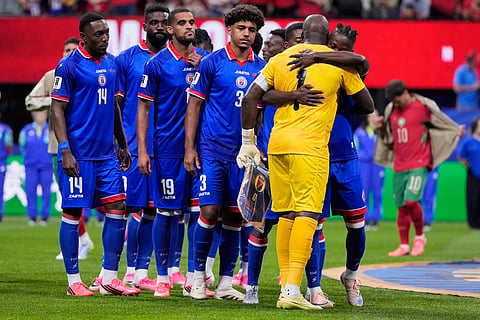 Haiti goalkeeper Johny Placide (1) embraces teammates before the World Cup Group C soccer match between Morocco and Haiti in Atlanta, Wednesday, June 24, 2026.