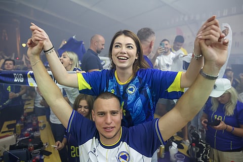 Bosnian national team soccer fans react as they watch a broadcast of the FIFA World Cup Group B soccer match between Bosnia and Qatar, at a fan zone in in Sarajevo, Bosnia, Wednesday, June 24, 2026.