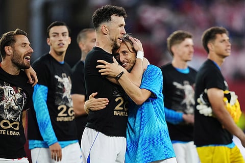 Croatia's Luka Modric, center right, celebrates with Ivan Perisic after defeating Panama as teammates wear shirts honouring his 200th appearance for Croatia following a World Cup Group L soccer match, in Toronto.