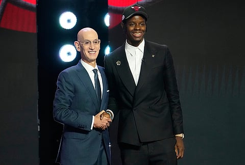Caleb Wilson, right, poses for a photo with NBA Commissioner Adam Silver, left, after being selected by the Chicago Bulls in the first round of the NBA basketball draft, in New York.