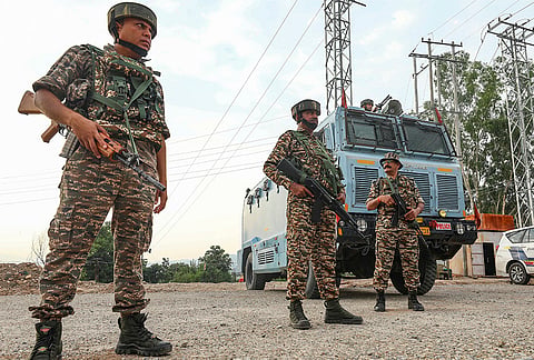 Security personnel stand guard along the Jammu and Kashmir National Highway ahead of the annual Shri Amarnath Yatra, in Jammu.