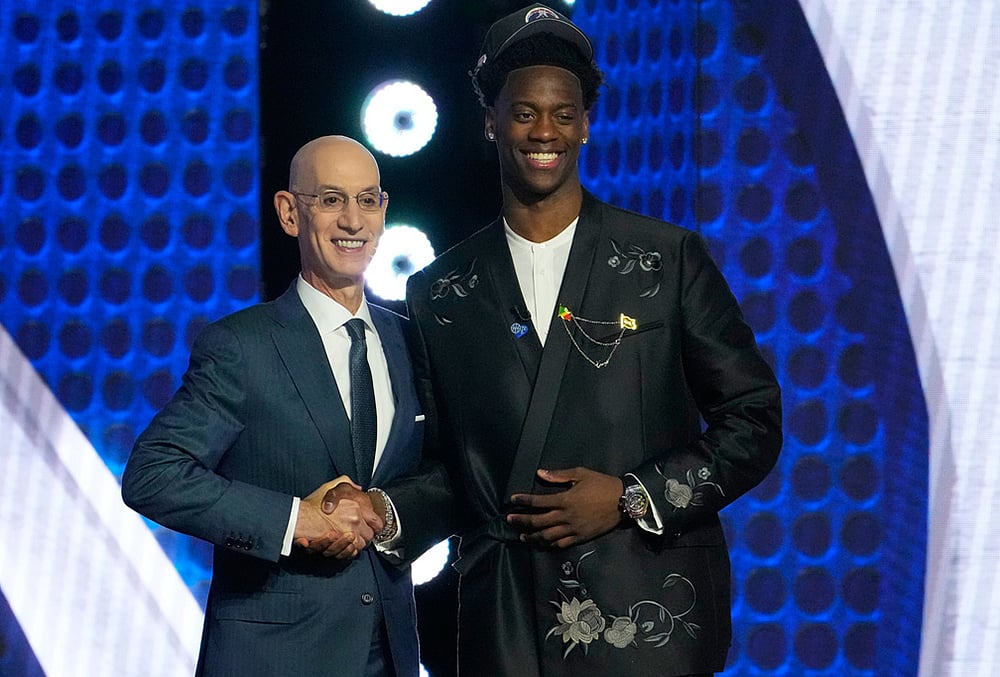 AJ Dybantsa, right, poses for a photo with NBA commissioner Adam Silver, left, after being selected by the Washington Wizards as the first pick in the first round of the NBA basketball draft in New York.  - | Photo: AP/Yuki Iwamura