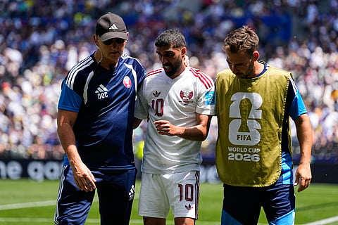Qatar's Hassan Alhaydos, center, is helped off the field by medical staff after sustaining an injury during the World Cup Group B soccer match against Qatar in Seattle, Wednesday, June 24, 2026.