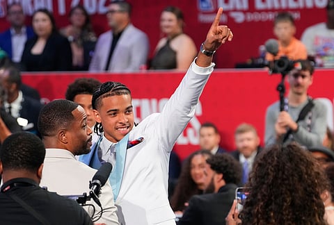 Mikel Brown Jr. gestures after being selected by the Brooklyn Nets with the No. 6 overall pick in the NBA Draftin the first round of the NBA basketball draft, in New York. 