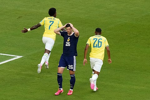 Brazil's Vinicius Junior (7) celebrates his goal with Rayan (26) as Scotland's Scott McKenna (26) reacts during the World Cup Group C soccer match between Scotland and Brazil in Miami Gardens, Fla., Wednesday, June 24, 2026.