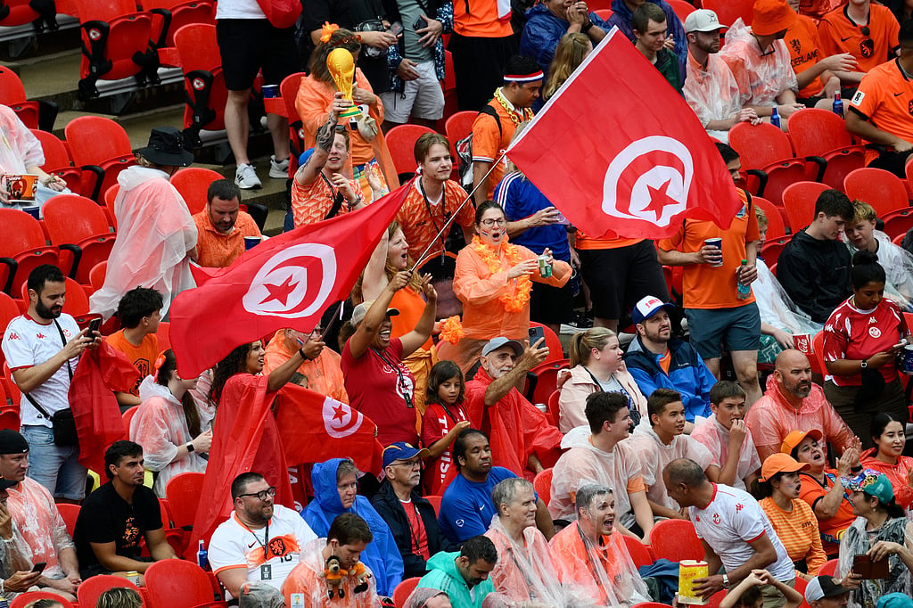 Tunisia fans wave flags ahead of the World Cup Group F soccer match between Tunisia and the Netherlands in Kansas City - Reed Hoffmann/AP Photo