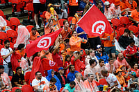 Reed Hoffmann/AP Photo : Tunisia fans wave flags ahead of the World Cup Group F soccer match between Tunisia and the Netherlands in Kansas City