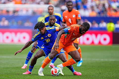 Curaçao's Leandro Bacuna (10) and Ivory Coast's Franck Kessie (8) fight for the ball during the World Cup Group E soccer match between Curacao and Ivory Coast in Philadelphia, Thursday, June 25, 2026.