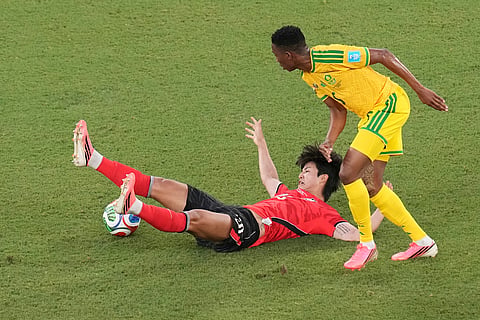 South Korea's Seol Young-woo (22) falls during the World Cup Group A soccer match between South Africa and South Korea in Guadalupe, near Monterrey, Mexico, Wednesday, June 24, 2026.