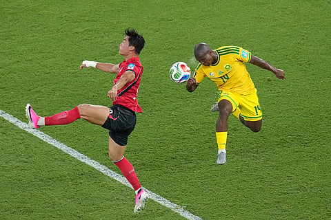 South Korea's Oh Hyeon-gyu (18) and South Africa's Mbekezeli Mbokazi (14) battle for the ball during the World Cup Group A soccer match between South Africa and South Korea in Guadalupe, near Monterrey, Mexico, Wednesday, June 24, 2026.