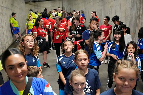 People wait in a tunnel during a lightning delay before the World Cup Group F soccer match between Tunisia and the Netherlands in Kansas City