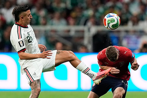 Mexico's Roberto Alvarado (25) plays at the ball as Czechia's David Doudera (21) reacts during the World Cup Group A soccer match between Czechia and Mexico in Mexico City, Wednesday, June 24, 2026.