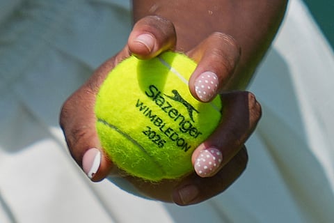 Serena Williams of the United States holds a ball during a practice session ahead of the Wimbledon Tennis Championships, in London.