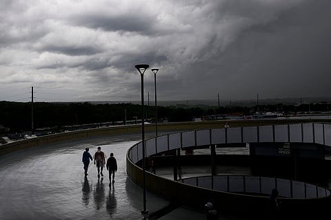 Fans brave the rain to take a ramp up to the stands at Kansas City Stadium before the World Cup Group F soccer match between Tunisia and the Netherlands in Kansas City