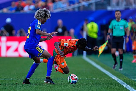 Curaçao's Tahith Chong (21) tackles Ivory Coast's Christ Inao Oulai (26) during the World Cup Group E soccer match between Curacao and Ivory Coast in Philadelphia, Thursday, June 25, 2026.