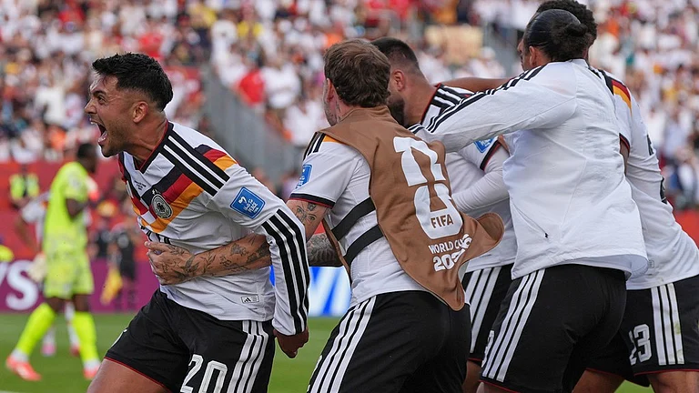 Germany's Deniz Undav, at center, is mobbed by teammates as he celebrates after scoring his side's second goal, as Germany's Nadiem Amiri, reacts towards the crowd during the World Cup Group E soccer match between Germany and Ivory Coast. - Stephanie Scarbrough/AP Photo