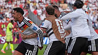 Stephanie Scarbrough/AP Photo : Germany's Deniz Undav, at center, is mobbed by teammates as he celebrates after scoring his side's second goal, as Germany's Nadiem Amiri, reacts towards the crowd during the World Cup Group E soccer match between Germany and Ivory Coast.