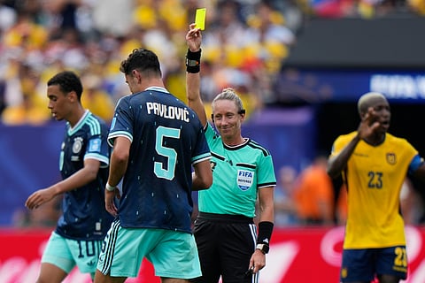Referee Tori Penso, of the United States, issues a yellow card to Germany's Aleksandar Pavlovic (5) during the World Cup Group E soccer match between Ecuador and Germany in East Rutherford, N.J., near New York, Thursday, June 25, 2026.