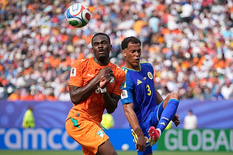 Ivory Coast's Ange-Yoan Bonny (9), left, fights for the ball with Curaçao's Jurien Gaari (3) during the World Cup Group E soccer match between Curacao and Ivory Coast in Philadelphia, Thursday, June 25, 2026.