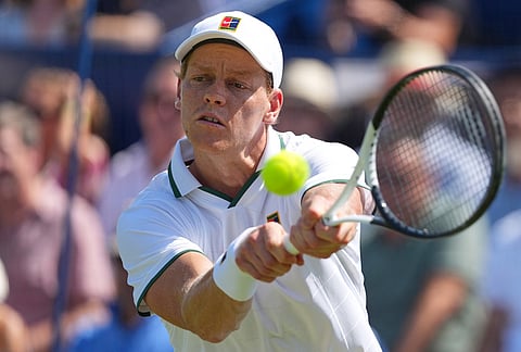 Jannik Sinner of Italy returns during a tennis exhibition match against Cameron Norrie of Great Britain in London.
