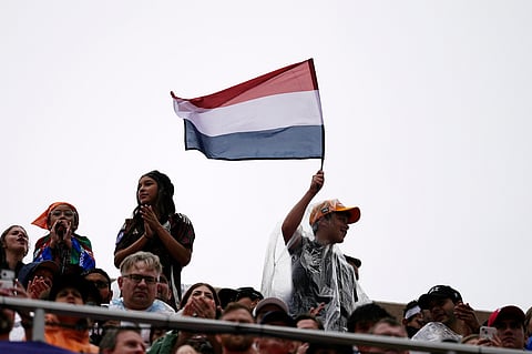 A Netherlands fan waves a flag before the World Cup Group F soccer match between Tunisia and the Netherlands in Kansas City