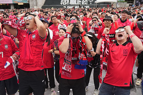Soccer fans react as they watch a live broadcasting of the World Cup Group A soccer match between South Africa and South Korea at a public viewing venue in Seoul, South Korea, Thursday, June 25, 2026.