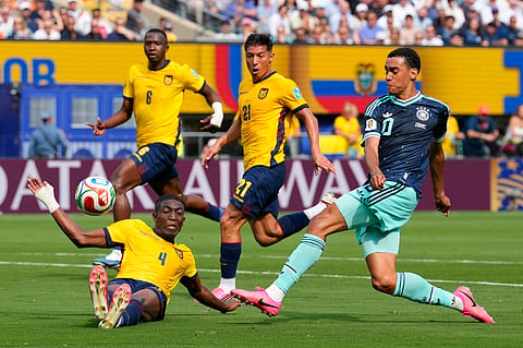 Germany's Jamal Musiala (10) kicks the ball as Ecuador's Joel Ordonez falls during the World Cup Group E soccer match in East Rutherford, N.J., near New York, Thursday, June 25, 2026.