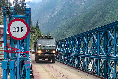 A vehicle crosses the 140-foot Triple Double Reinforced Bailey Bridge after it became operational, at Chishoti in the Padder region of Kishtwar district.