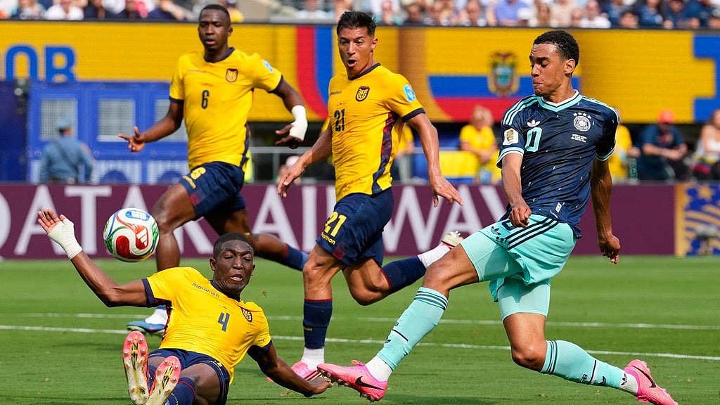 Germany's Jamal Musiala (10) kicks the ball as Ecuador's Joel Ordonez falls during the World Cup Group E soccer match in East Rutherford. - Yuki Iwamura/AP Photo
