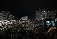 | Photo: AP/Javier Campos : Rescue workers search through the rubble after an earthquake in Caracas, Venezuela.