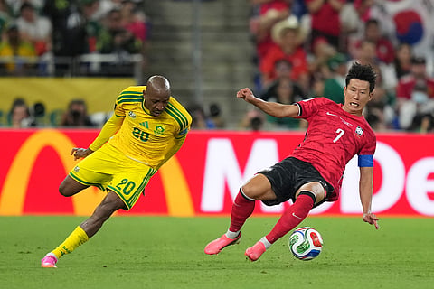 South Korea's Son Heung-min (7), right, fights for the ball with South Africa's Khuliso Mudau (20) during the World Cup Group A soccer match between South Africa and South Korea in Guadalupe, near Monterrey, Mexico, Wednesday, June 24, 2026.