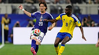 Tony Gutierrez/AP Photo : Japan's Ayumu Seko, left, is challenged by Sweden's Alexander Isak during the World Cup Group F soccer match in Arlington.