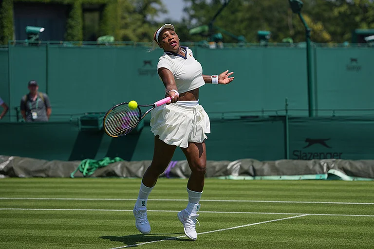 Serena Williams of the United States plays a return during a practice session ahead of the Wimbledon Tennis Championships, in London. - | Photo: AP/Kin Cheung