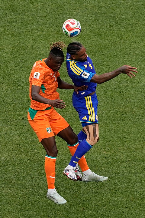 Ivory Coast's Odilon Kossounou (7) battles for a header with Curaçao's Juergen Locadia (9) during the World Cup Group E soccer match between Curacao and Ivory Coast in Philadelphia, Thursday, June 25, 2026.