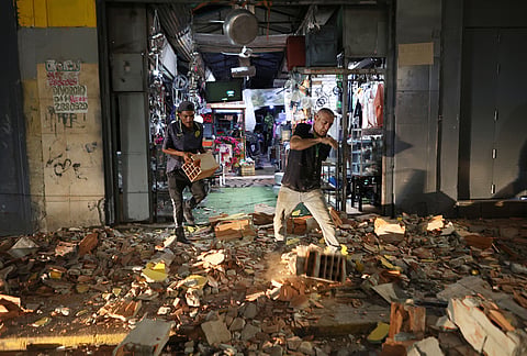 Men walk among rubble after an earthquake in Caracas, Venezuela.