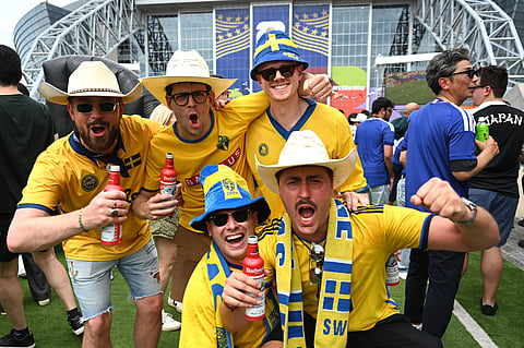 Fans cheer outside the stadium before the World Cup Group F soccer match between Japan and Sweden in Arlington