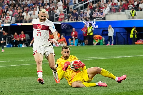 United States goalkeeper Matt Turner (1) takes the ball as Turkey's Baris Alper Yilmaz (21) runs in during the World Cup Group D soccer match between Turkey and the United States in Inglewood, Calif., near Los Angeles, Thursday, June 25, 2026.