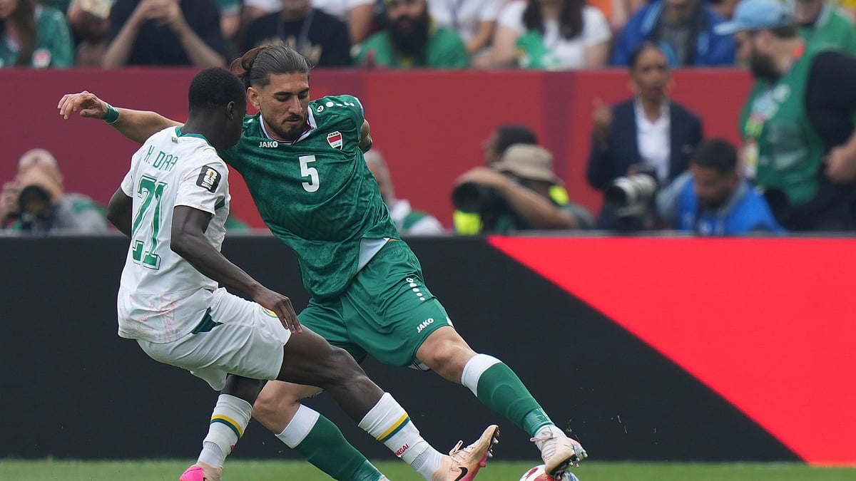 Iraq's Akam Hashim (5) moves the ball past Senegal's Habib Diarra (21) during the World Cup Group I soccer match between Senegal and Iraq in Toronto, Friday, June 26, 2026. - (AP Photo/Stephanie Scarbrough)