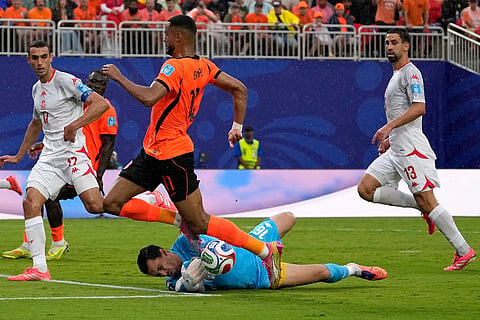 Tunisia goalkeeper Aymen Dahmen (16) blocks a shot by Netherlands' Cody Gakpo (11) during the World Cup Group F soccer match between Tunisia and the Netherlands in Kansas City, Mo., Thursday, June 25, 2026.