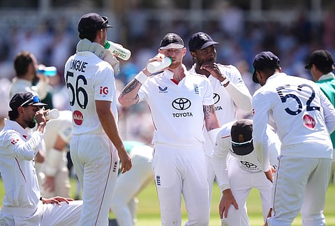 England's Ben Stokes, center and teammates take a drinks break during day one of the Third Test cricket match between England and New Zealand, in Nottingham, England.
