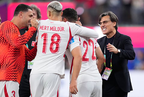 Turkey head coach Vincenzo Montella congratulates Kaan Ayhan at the end of the World Cup Group D soccer match against the United States in Inglewood, California, near Los Angeles.