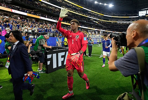Japan goalkeeper Zion Suzuki waves after the World Cup Group F soccer match against Sweden in Arlington, Texas, near Dallas.