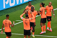 (AP Photo/Reed Hoffmann) : Netherlands' Brian Brobbey (19) celebrates their second goal with Virgil van Dijk (4) and teammates during the World Cup Group F soccer match between Tunisia and the Netherlands in Kansas City, Mo., Thursday, June 25, 2026.