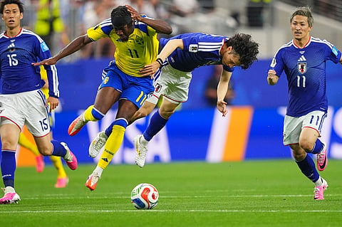 Sweden's Anthony Elanga, left, and Japan's Ao Tanaka battle for the ball during the World Cup Group F soccer match in Arlington
