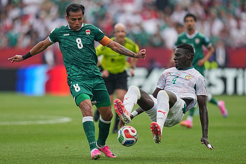 Iraq's Ibrahim Bayesh (8) battles for the ball with Senegal's Abdoulaye Seck (4) during the World Cup Group I soccer match between Senegal and Iraq in Toronto, Friday, June 26, 2026.