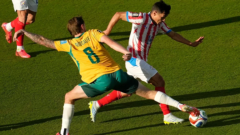 araguay's Andres Cubas (14) is challenged by Australia's Connor Metcalfe (8) during the World Cup Group D soccer match between Paraguay and Australia in Santa Clara, Calif., near San Francisco, Thursday, June 25, 2026 - (AP Photo/Jeff Chiu)