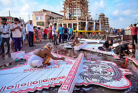 Artists, also known as ‘Chitrakars’, paint the parts of chariots of Lord Jagannath, Lord Balabhadra and Goddess Subhadra ahead of the annual Rath Yatra, in Puri, Odisha.