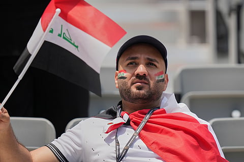 A fan of Iraq waves a flag ahead of the World Cup Group I soccer match between Senegal and Iraq in Toronto, Friday, June 26, 2026.
