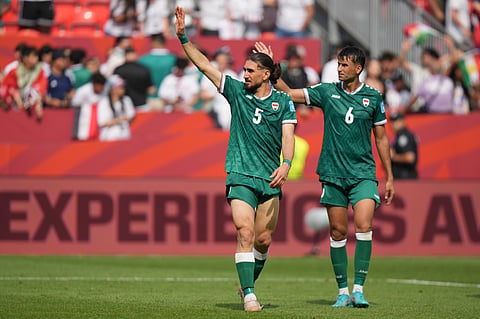 Iraq's Akam Hashim (5) and Munaf Younus (6) wave to supporters as they leave the pitch after their loss in the World Cup Group I soccer match between Senegal and Iraq in Toronto, Friday, June 26, 2026. 
